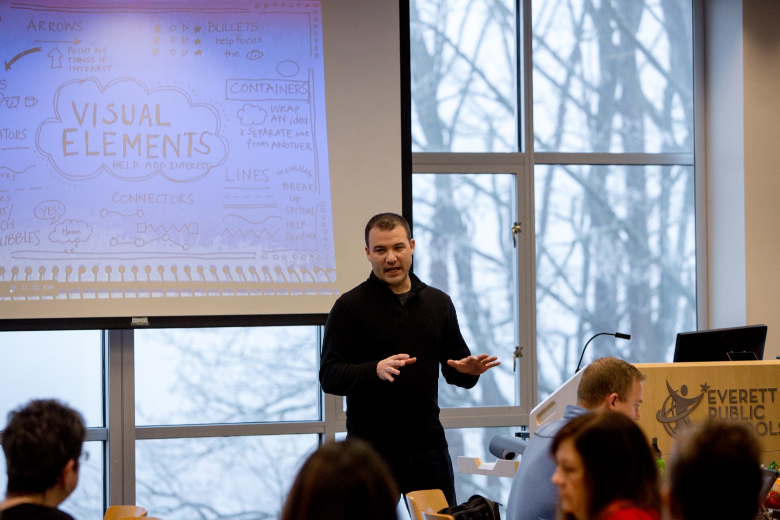 Jeff Utecht leading a workshop session in front of a projected visual elements slide